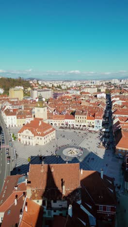 aerial drone perspective of city center of brasov. drone passing forward from black church to the council square. famous travel destination in romania. vertical footage