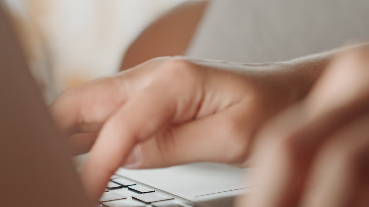 Hands typing computer. Person uses laptop for booking in cozy hotel room morning. Individual concentrates on online reservation using laptop in comfortable hotel environment during daylight