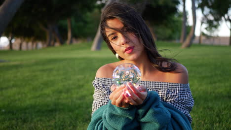 a beautiful sorceress holding a magic glowing crystal ball and tempting fate