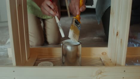 father and son painting furniture