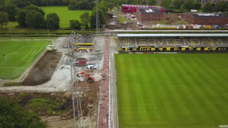 machinery on a sports field during its final construction process