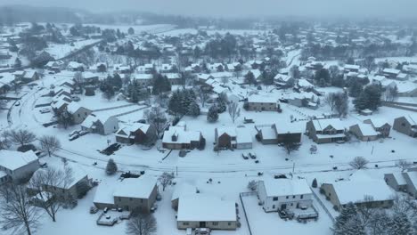 high aerial of housing development covered in snow during winter