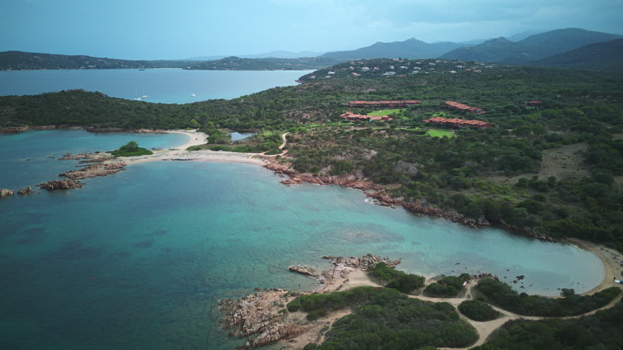 Drone timelapse panning left over Spiaggia Cala Finanza, Sardinia — turquoise waters