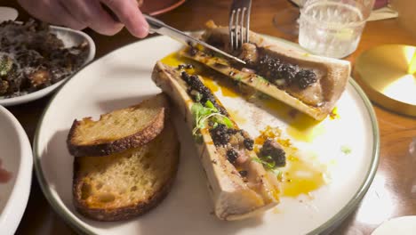 gourmet meal featuring bone marrow and toast