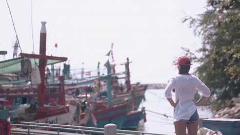 young woman in blue denim shorts and long white shirt