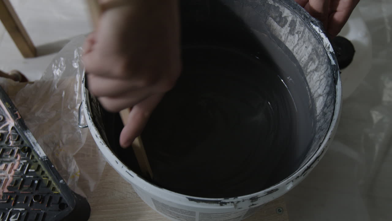 Mixing Gray Paint in a Bucket