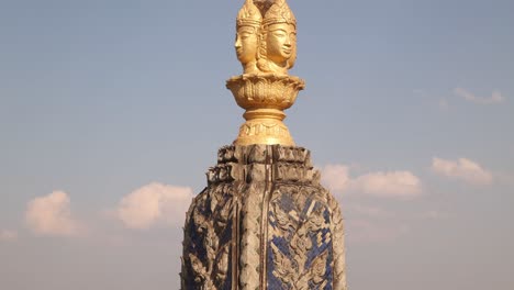 golden buddha face on spire above patuxai victory monument in the center of vientiane, laos