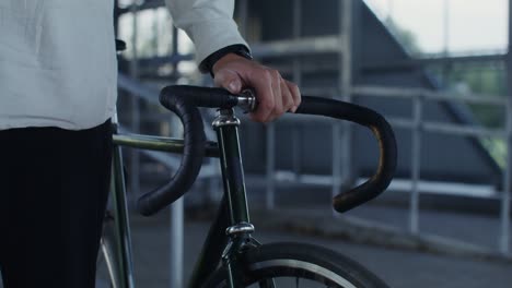 man holding fixed gear bike handlebar