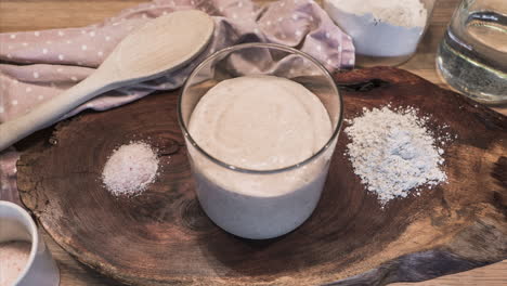 sourdough starter yeast culture rising and bubbling in an open jar - high angle, time lapse