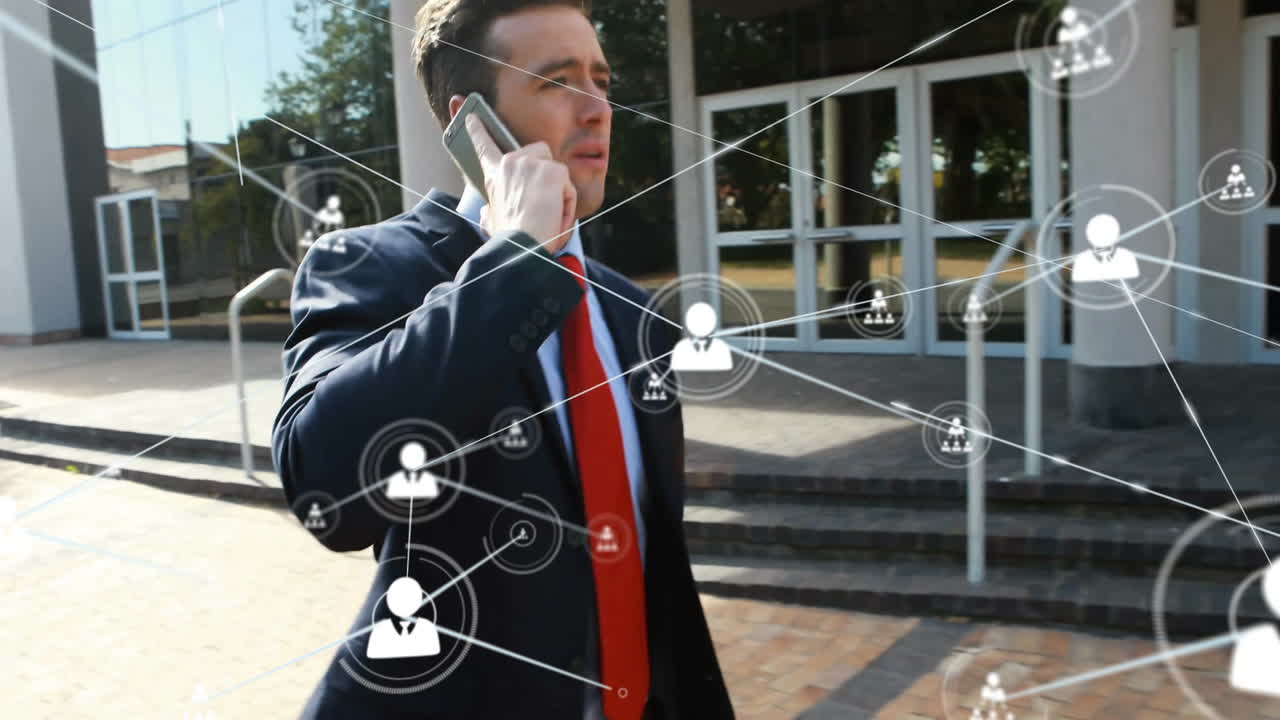 Talking on smartphone, businessman with network connections animation over office building