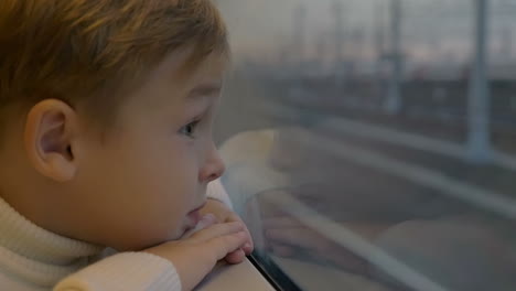 boy by the train window