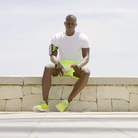 man with brightly colored shorts and gym shoes