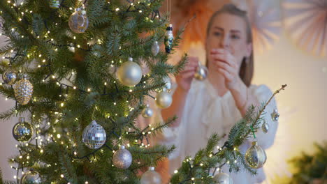 portrait of woman decorating christmas tree