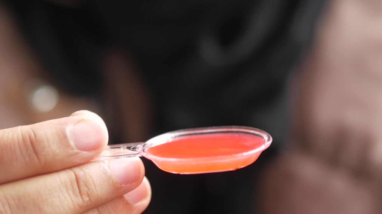 Pouring liquid medicine on spoon