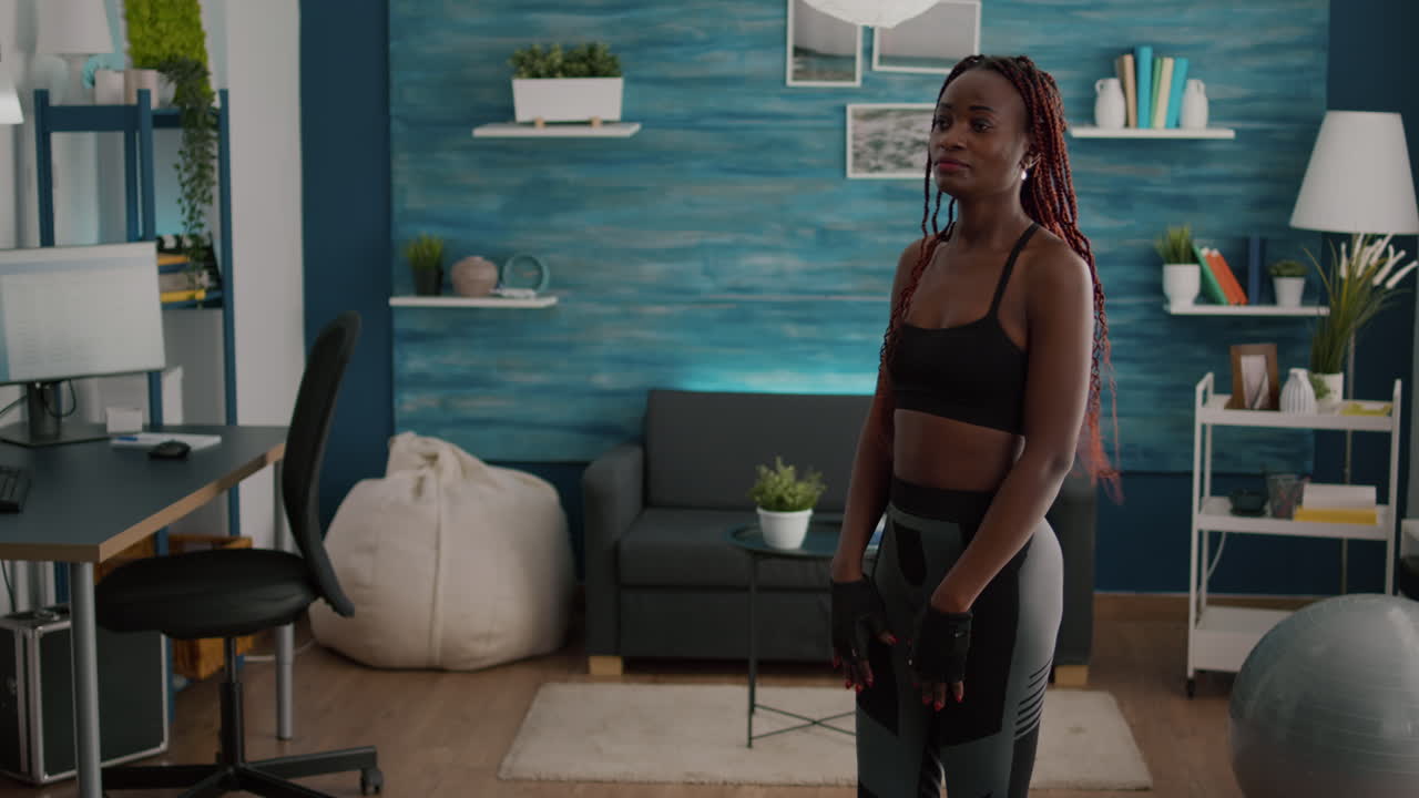 Slim fit athetic black woman wearing sportswear training leg stand posture