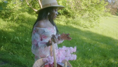 Black-Woman-with-basket-walking-into-park-following