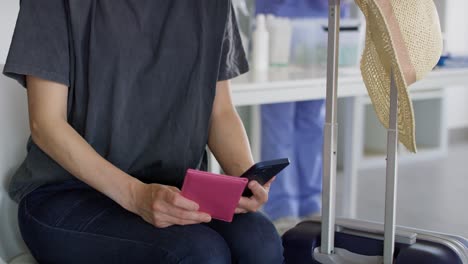 Tilt-up-video-of-woman-holding-digital-covid-19-vaccine-passport