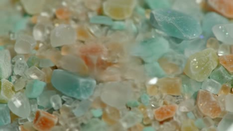 a close-up view of various colorful crystals and minerals showcasing natural textures and intricate patterns in a vibrant mosaic of tiny gems