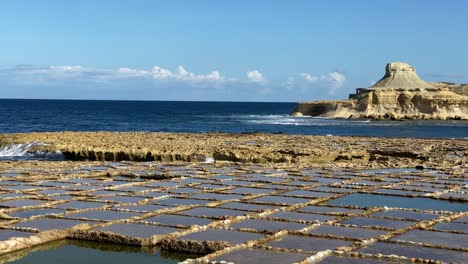 historic rectangular patterned xwejni salt pans, gozo island, malta, low angle