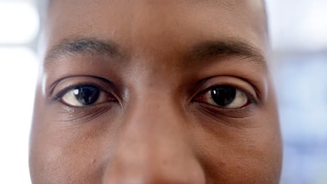 portrait of happy eyes of african american man in hospital, slow motion