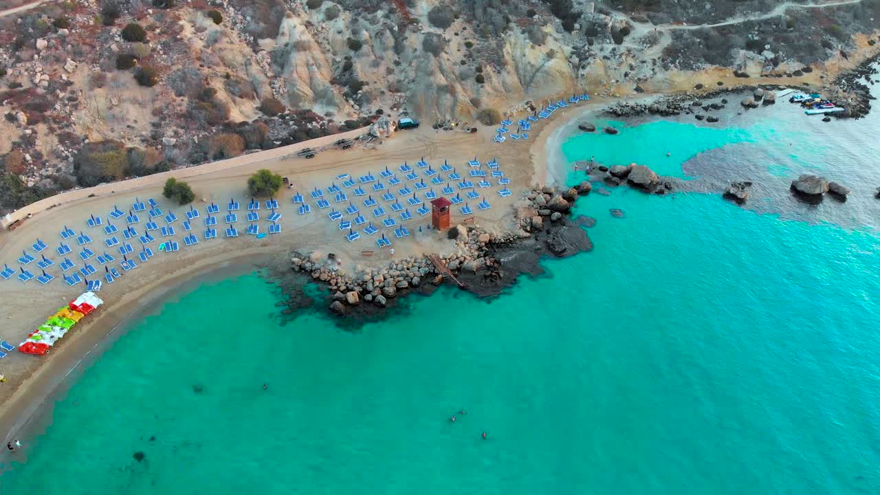 Aerial drone shot approaching a lifeguard tower on the beach at Konnos Bay in Europe