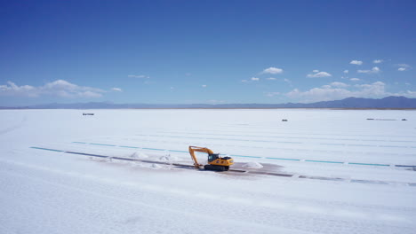Aerial-of-excavator-extracting-salt-at-Salinas-Grandes-in-Argentina
