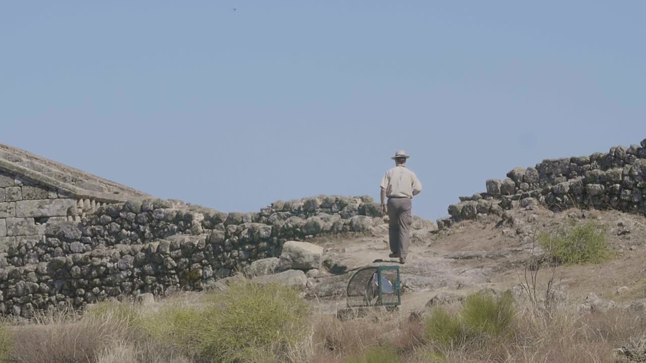 Man Walking Through Ancient Ruins