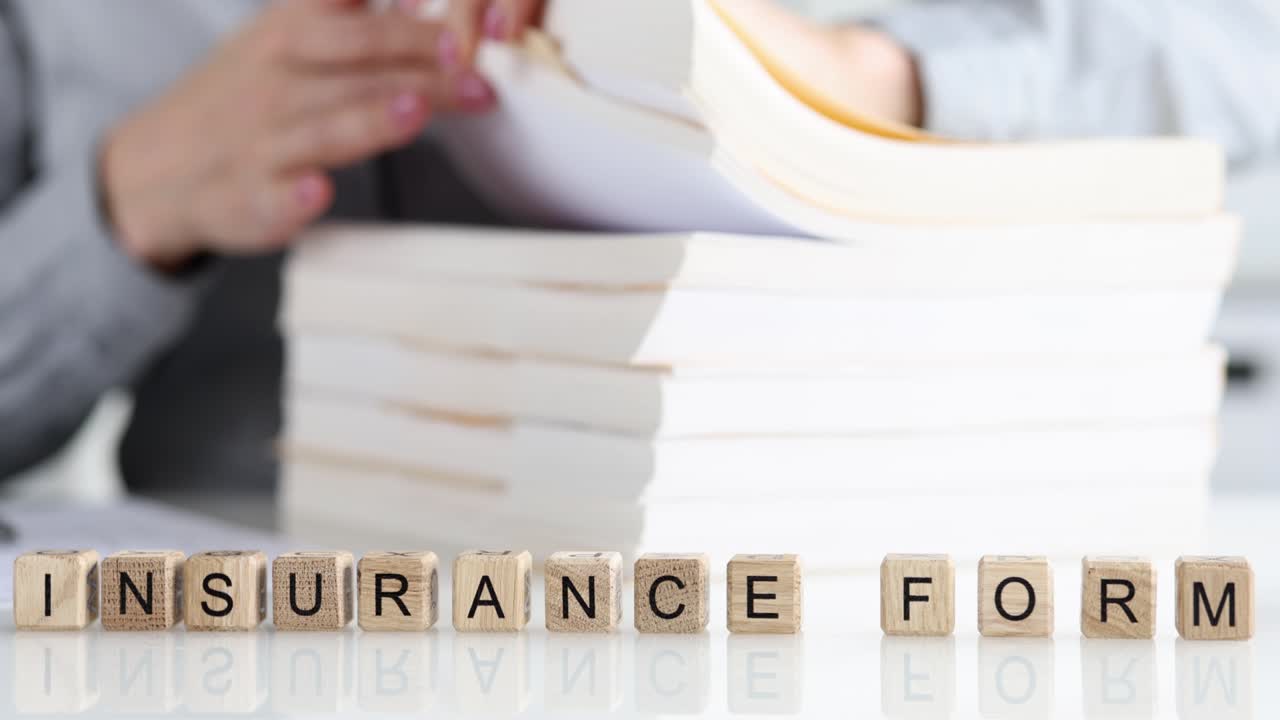 Agent leafs through insurance form in office closeup