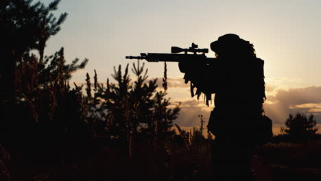 a solider aims his rifle 8