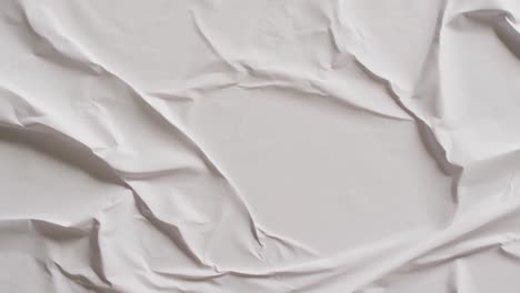 Video-of-close-up-of-white-creased-fabric-with-copy-space