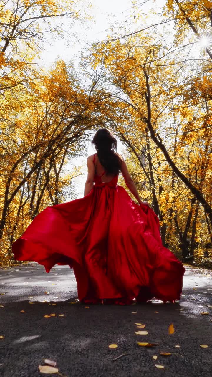 A Graceful Dancer in a Flowing Red Dress, Surrounded by Autumn's Golden Landscape, Captures the Essence of Nature's Beauty and Elegance