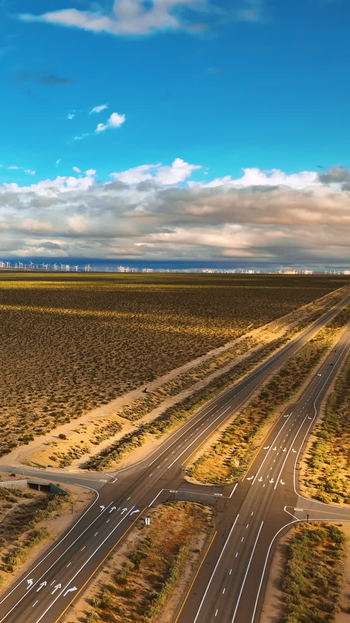 Amazing view of the deserted landscape shaded by the clouds. Mountains at backdrop. Drone rising over the highways in Nevada, USA. Vertical video