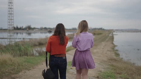 two women walking along a country road