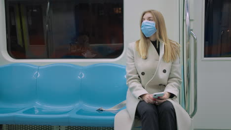 woman on subway wearing a mask