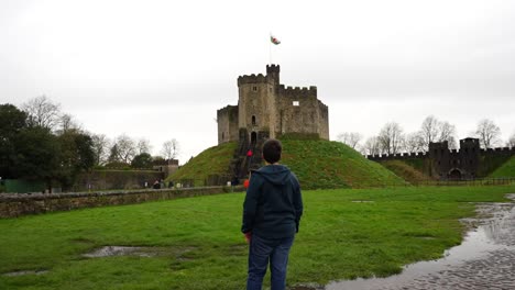 Male-tourist-enjoy-his-visit-to-Cardiff-Castle-in-front-of-Normand-Fortress