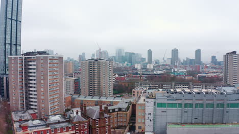 descending aerial drone shot of city of london skyscrapers cloudy from north london