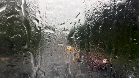 rain running down the front window of a double decker bus