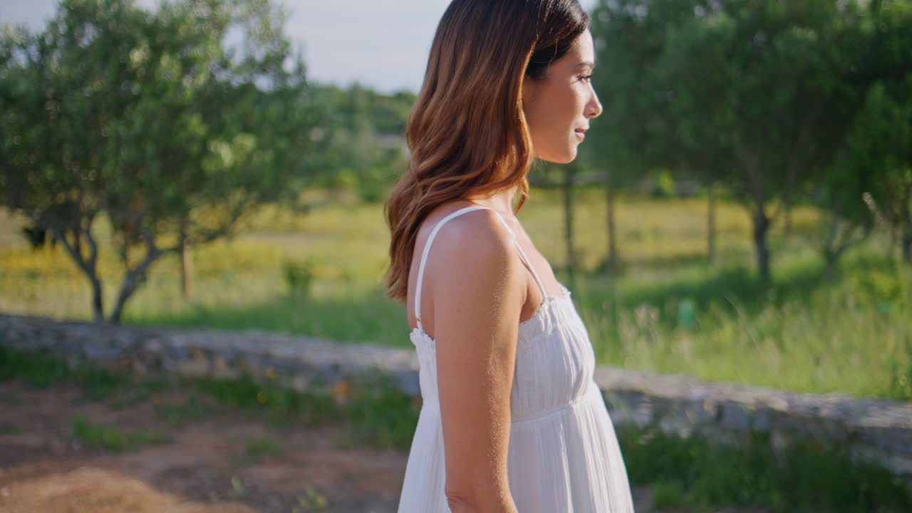 Woman enjoy walk garden summer evening portrait. Brunette looking camera posing
