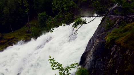 Raging-Fossevandring-waterfall,-Geiranger-Norway,-pan-to-beautiful-Norwegian-fjord-and-cruise-ship,-4k-ProRezHQ