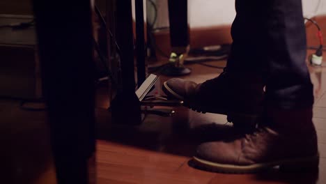 piano pedals peing pumped while performer plays