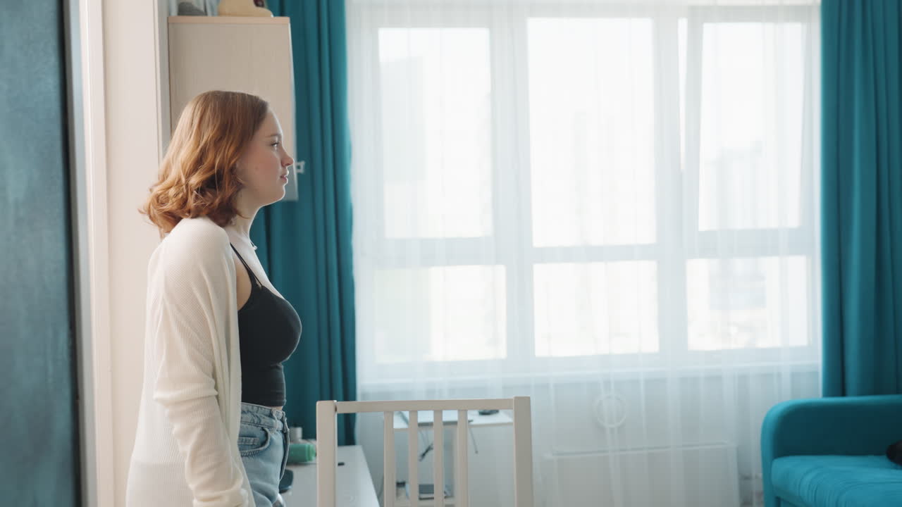 Casual Meeting With Hugs And Handshakes Indoors, Woman And Friend Exchange Warm Greetings By Teal Sofa, Friendly Woman Welcomes Her Friend With Hug And Handshake Beside Natural Light