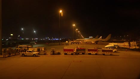 planes and vehicles at suvarnabhumi airport at night