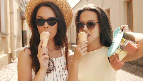 two friends enjoying ice cream and a sunny day in the city