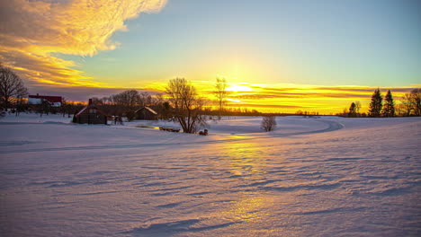 Timelapse-of-clouds-moving-in-sky-with-bright-rising-sun-over-snowy-landscape-at-sunrise