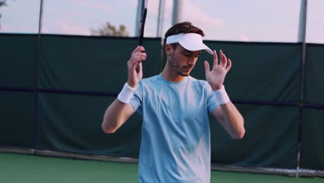male tennis player preparing for a match on the court