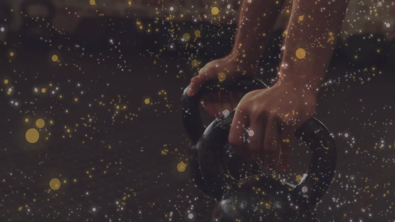 Man gripping kettlebells, lowering torso on floor, pressing up for fitness with sparkle overlay