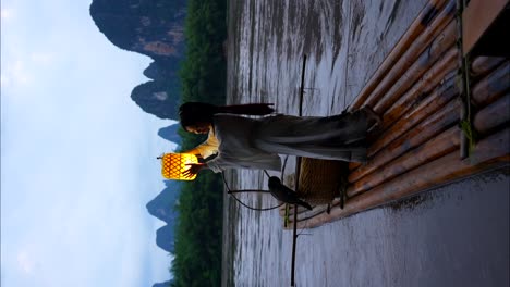 Hanfu-girl-with-an-illuminated-lantern-on-a-raft-in-Li-River-at-dusk