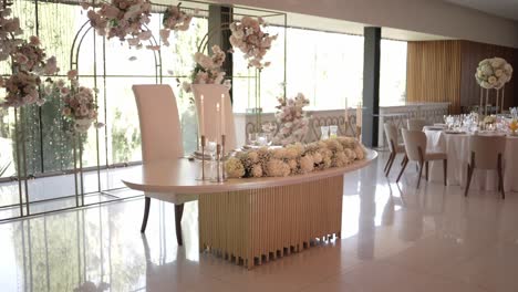 elegant sweetheart table decorated with white floral arrangements in a modern wedding venue