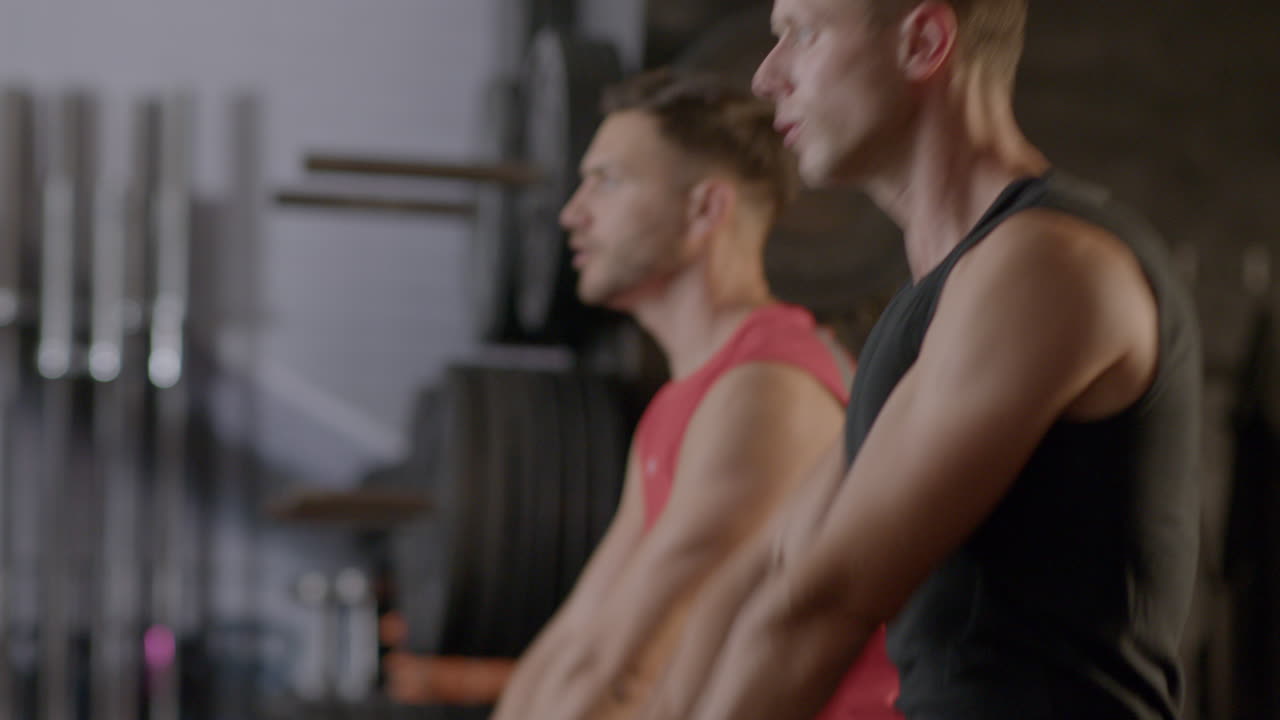 Men exercising with kettlebells in a gym