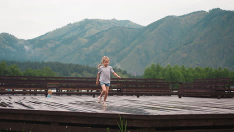 Girl-with-plait-runs-having-fun-along-ground-at-highland